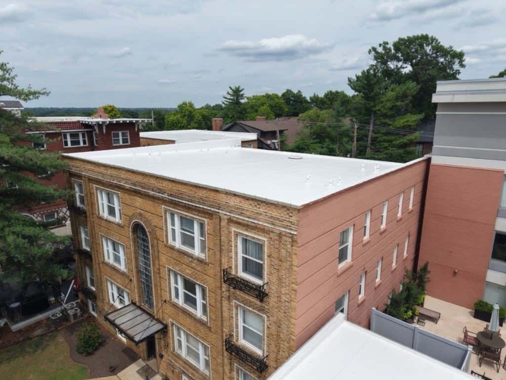 Drone view of a flat roof on a brick apartment building