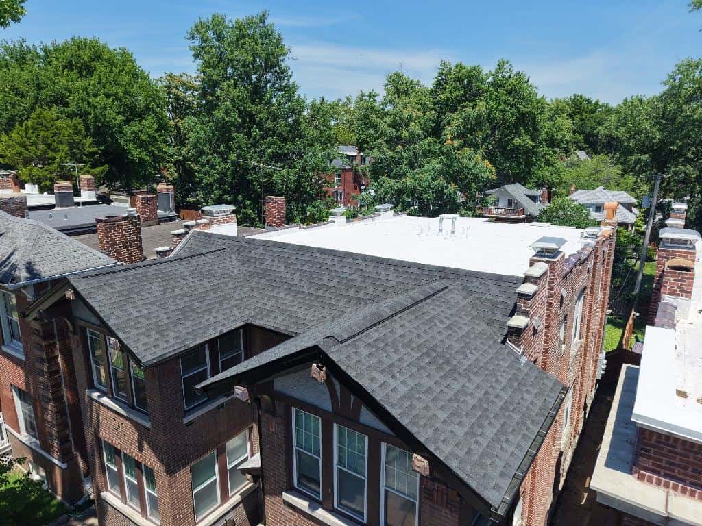 Drone view of new shingles and gutters on a two-story home