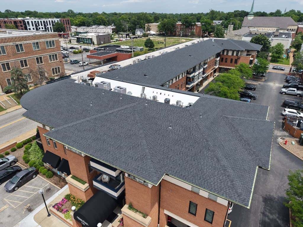 Aerial view of a large shingle roof on an apartment building
