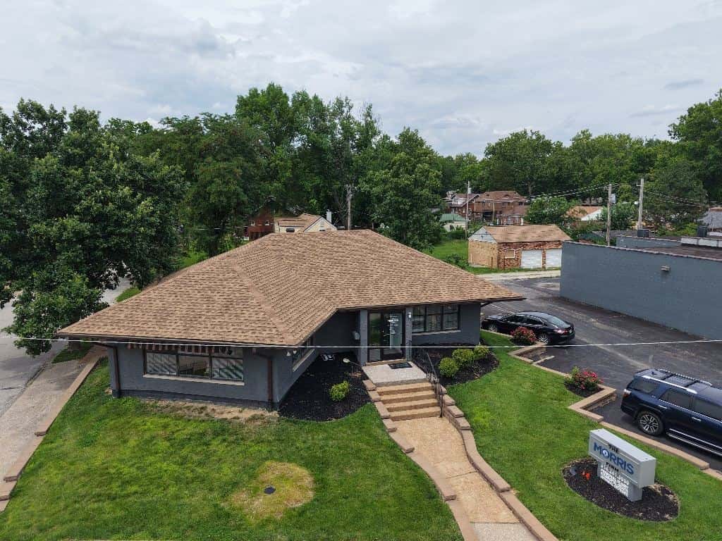 Single-story building with a new brown shingle roof