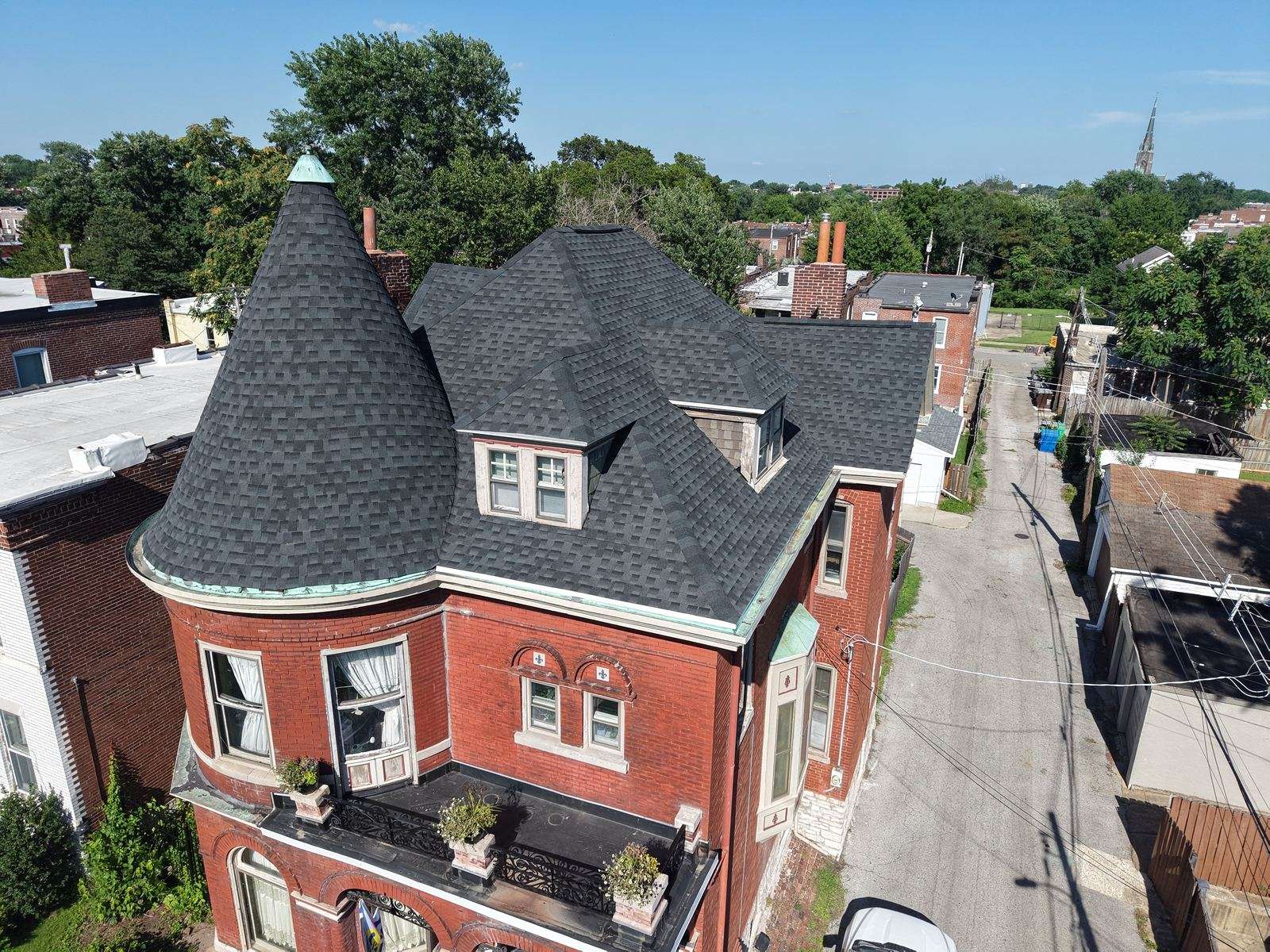Cox roof replacement on a brick Victorian home with a turret