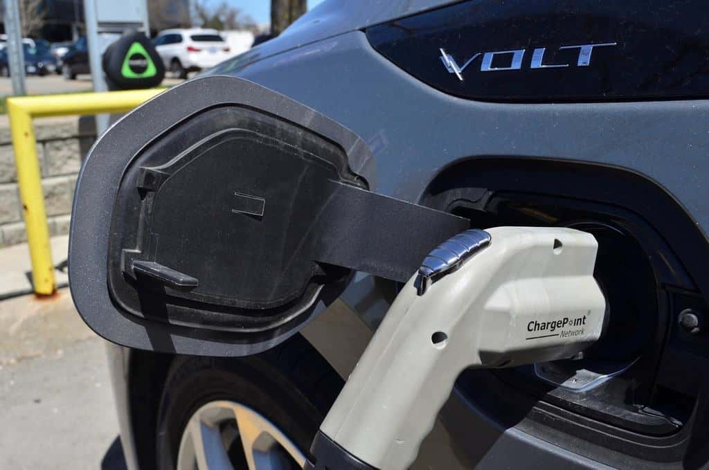 Electric vehicle plugged into a charging station